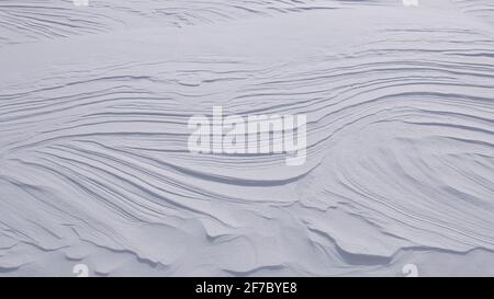 Natural wavy lines on surface of pure white snow Stock Photo
