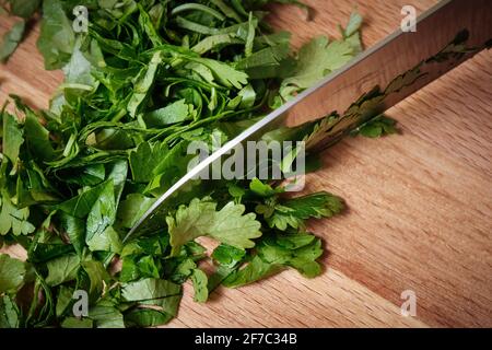Chopping parsley on a cutting board Stock Photo
