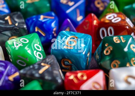 Image of a marbled turquoise 6 sided die surrounded by multiple RPG dice in various colors Stock Photo