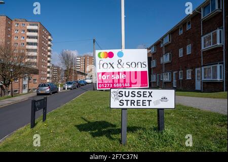 A Fox & Sons estate agents For Sale sign at the end of Sussex Street in Brighton UK Stock Photo