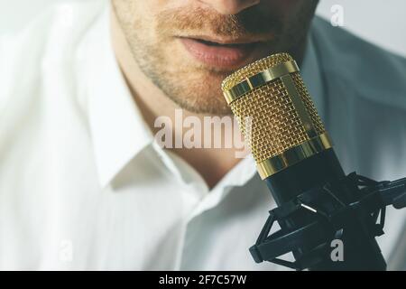 young man recording podcast. speaking in microphone closeup Stock Photo
