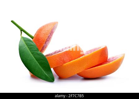 Sliced grapefruit with green leaf isolated on white background. Stock Photo