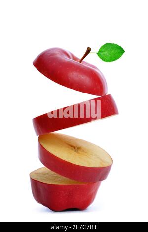 Sliced red apple with green leaf isolated on white background. Stock Photo