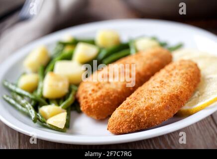 Breaded Fish Fillet with Potatoes and Green Beans. Stock Photo