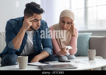 Puzzled muslim family feeling worry about their spendings Stock Photo