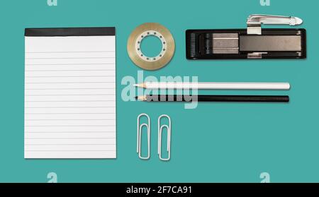 Office and school stationery on cyan background. Flat lay. Stock Photo