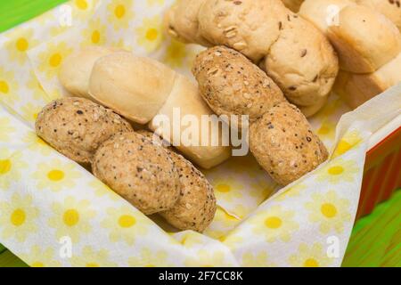 Flower shaped fresh bread rolls in colorful paper napkins Stock Photo