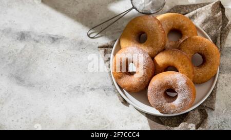 Homemade donuts on grey cement background. Food concept. Copy space. Stock Photo