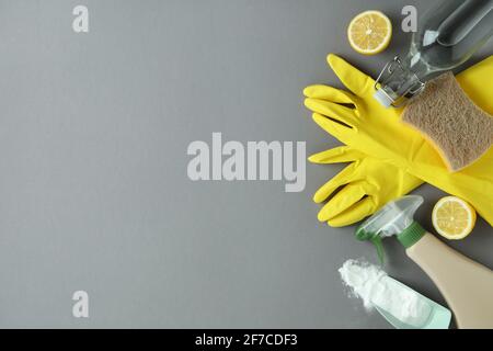 Cleaning concept with eco friendly cleaning tools and lemons on gray background Stock Photo