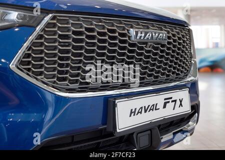 Russia, Izhevsk - February 17, 2021: Haval logo on a bumper of new car F7X at dealership showroom. Car manufacturer from China. Modern transportation. Stock Photo