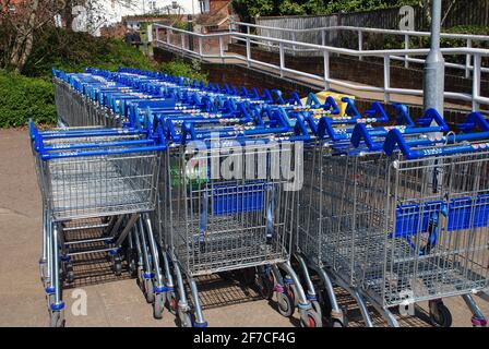 Rows of shopping trolleys outside a branch of Tesco supermarket at Tenterden in Kent, England on April 4, 2021. Stock Photo