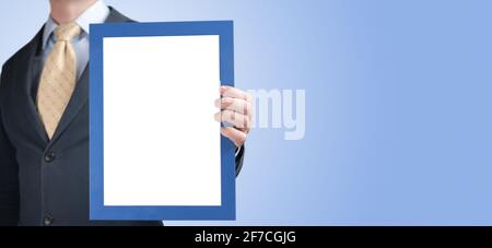 Mockup. Business man holding in hands empty blank photo frame. Banner with Businessman holding in hand blank a4 photo frame. man holding picture certi Stock Photo