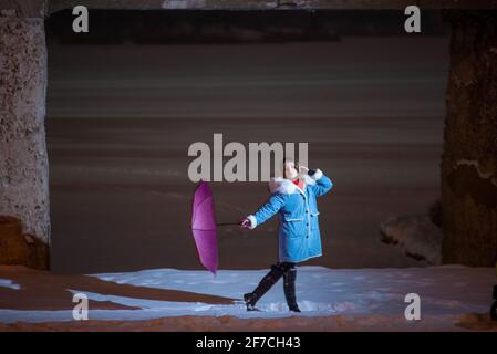 Girl with umbrella. young beautiful girl, in winter on the snow, posing with a pink umbrella Stock Photo