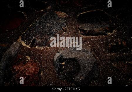 Black texture with light inclusions as a background. Stock Photo