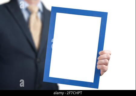 Mockup image. businessman holds the empty white board. man wearing business shirt holding blank picture frame. man holding poster mockup template with Stock Photo