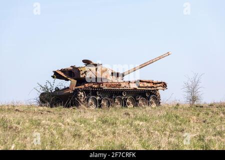 Ruins of a rusting abandoned tank near Imber village on MOD military training ground, Salisbury Plain, Wiltshire, England, UK Stock Photo