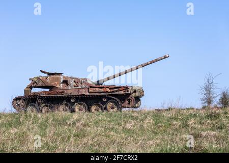 Ruins of a rusting abandoned tank near Imber village on MOD military training ground, Salisbury Plain, Wiltshire, England, UK Stock Photo