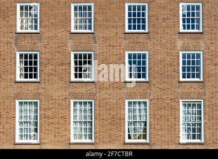 Brick wall with multiple windows in a brick wall with georgian windows multi framed glass windows rows of windows Stock Photo