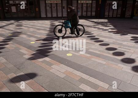 Deliveroo cyclist speeding through an empty Chinatown at lunchtime in London Stock Photo