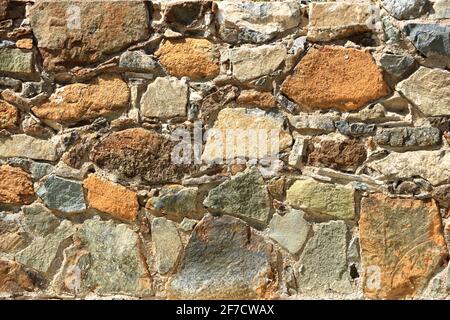 Background of a decorate orange green stone wall surface Stock Photo