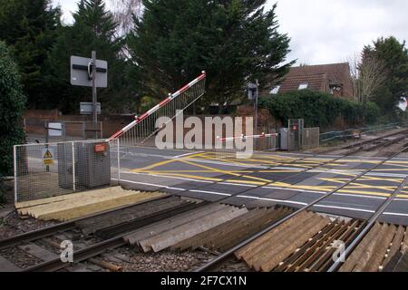21 March 2021 - Datchet, Berks: Level crossing barriers closing Stock Photo