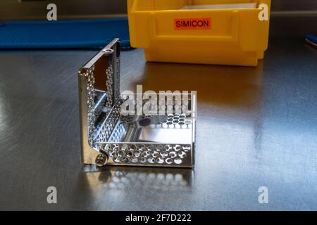 a simicon test for checking the cleaning performance of a washing machine in the operating room stands on a silver base Stock Photo