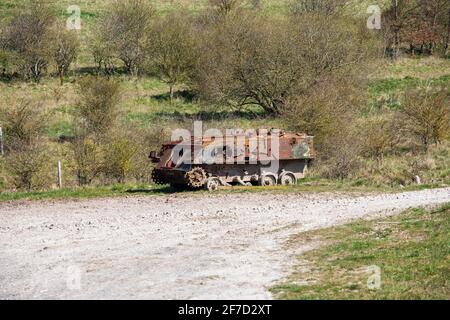 Ruins of a rusting abandoned tank near Imber village on MOD military training ground, Salisbury Plain, Wiltshire, England, UK Stock Photo