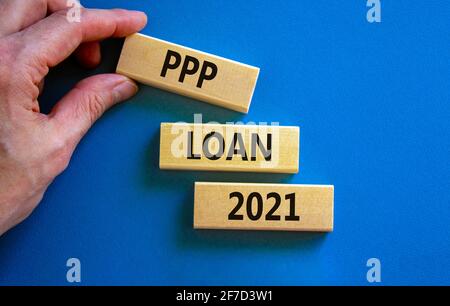 PPP, paycheck protection program loan 2021 symbol. Concept words PPP loan 2021 on blocks on a beautiful blue background. Business, PPP - paycheck prot Stock Photo