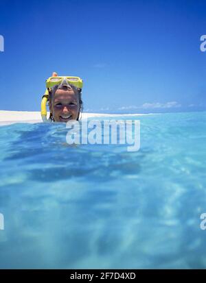 Young woman snorkeling on coral cay on Great Barrier Reef Marine Park, Queensland, Australia Stock Photo