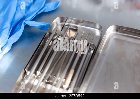 Dental instruments and medical gloves on the table Stock Photo