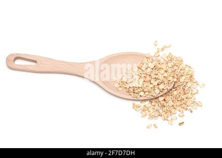 Raw oat flakes on wooden spoon isolated on white. Top view Stock Photo