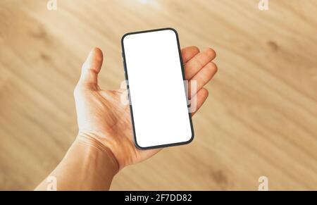 Mockup frameless phone with blank white screen in man hand, copy space photo Stock Photo
