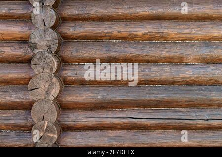 Rough wooden beams background, brown log wall texture close-up for building design. Stock Photo
