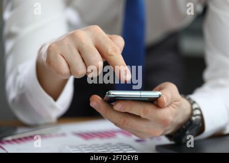 Close-up of businessman using modern smartphone closeup Stock Photo