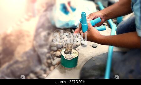 Fixing water pipe at home outdoor which broken or damage. Cause of leaking clean water and need to fix or maintenance by plumber suggestion such as ch Stock Photo