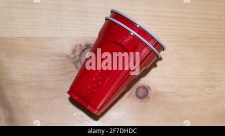 Stacked red party cups on a smooth hardwood countertop, Toronto, Ontario, Canada. Stock Photo