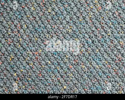 Speckle texture of knitted fabric. Multi-tone, mottled finish woven into the grey coloured textile Stock Photo