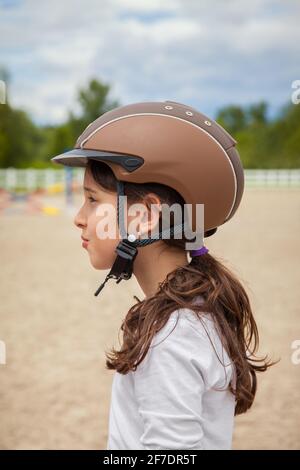 Young Girl Wearing a Horse Riding Helmet