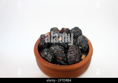 Ajwa dates. Dried dates. Prophet dates on white background. Iftar time Stock Photo