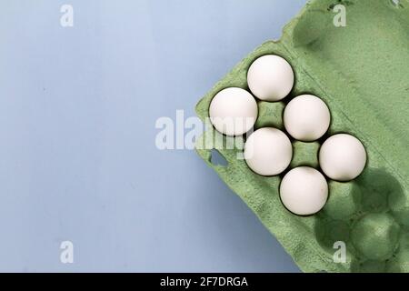 group of white chicken eggs on light blue background, empty space for text Stock Photo