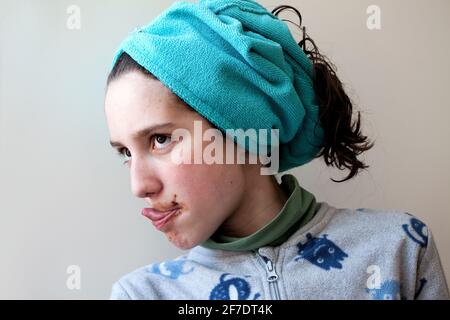 12 year-old boy licking chocolate off his lips. Stock Photo