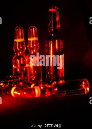 Medical ampoules close up. Many ampoules. Glass ampoules on the table. Scattered ampoules with medicine. Stock Photo