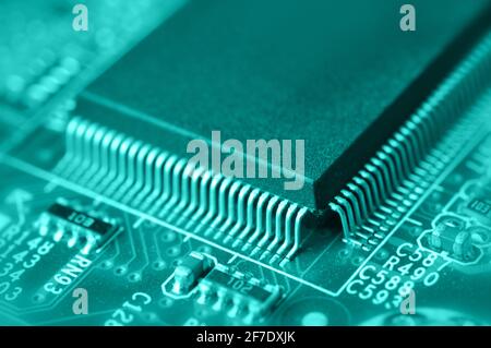 Closeup of electronic circuit board with chip in green tone. Macro with extremely shallow dof. Stock Photo