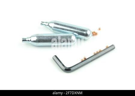 Co2 Cartridges, Pellets and Hex Key for Air Gun Isolated on White Background. Stock Photo