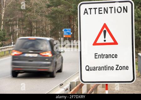 A road sign warns of the entrance to the quarantine zone. Stock Photo