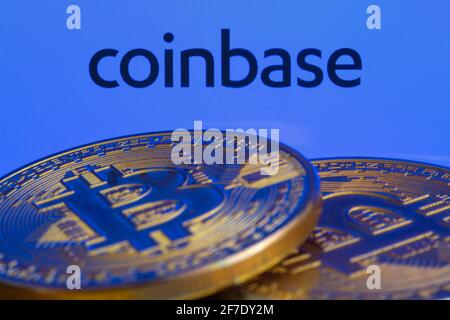 Coinbase logo on screen with Bitcoin coins. Ljubljana, Slovenia - April 06 2021 Stock Photo