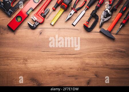 Assorted work tools on wooden background Stock Photo