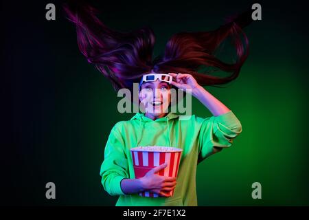 Photo of charming shocked lady wear green sweater watching scary movie eating popcorn isolated colored bright shine background Stock Photo