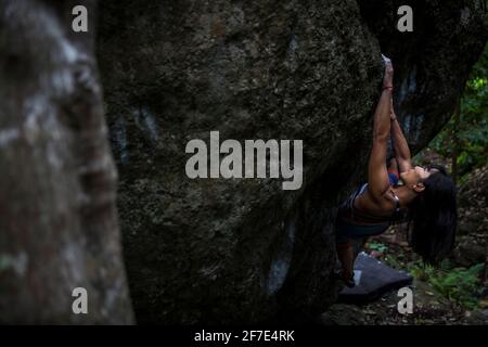 Sporty strong young woman in black outfit exercising in boulder climbing  hall reaching new results, enjoying new challenges Stock Photo - Alamy