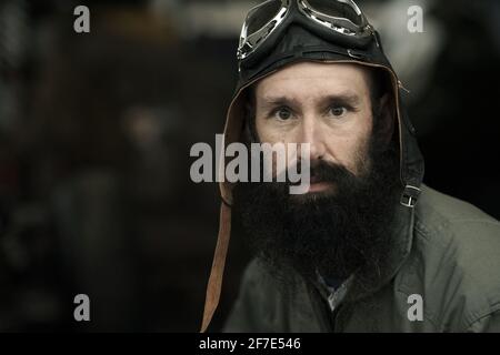 GREAT BRITAIN / England /portrait of a old fashioned racing driver wearing vintage flying hat and goggles. Portrait of male pilot . Stock Photo